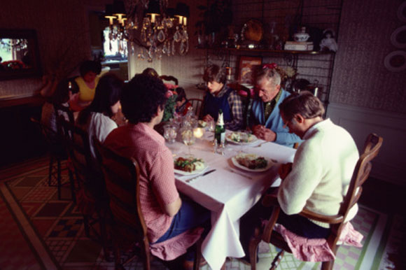 family saying grace at a meal
