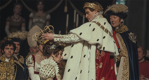 Vanessa Kirby as Josephine being crowned by Joaquin Phoenix as Napoleon