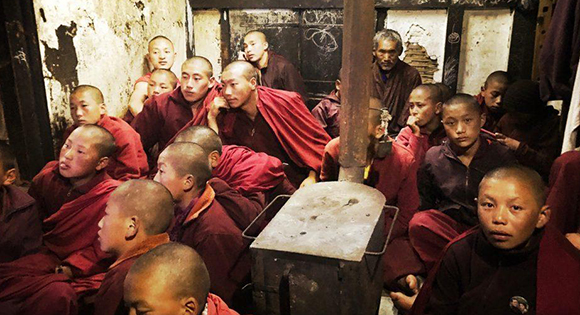 Young monks in Laya watching television.