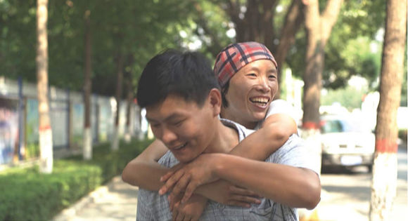 Liu Ximei hugging another AIDs patient who is smiling in Ximei