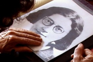 Simone Weil's niece Sylvie Weil flips though family photo album