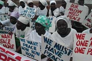 Liberian women demonstrate at the American Embassy in Monrovia at the height of the civil war in July 2003, Photo Credit: Pewee Flomok