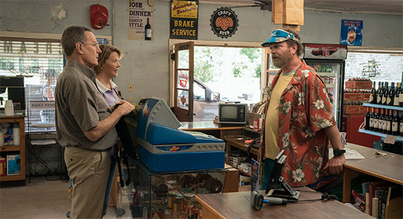 Bryan Cranston as Jerry and Annette Bening as Marge buying lottery tickets from Rainn Wilson.