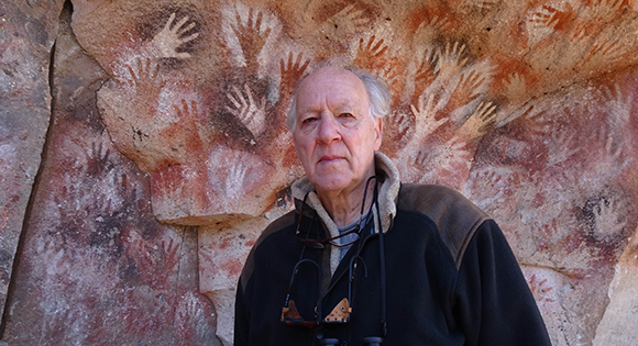 Director Werner Herzog in front of aboriginal rock paintings.