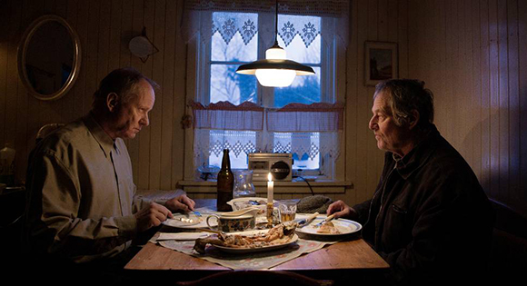 Trond (Stellan Skarsgard) having dinner with Lars (Bjorn Floberg)