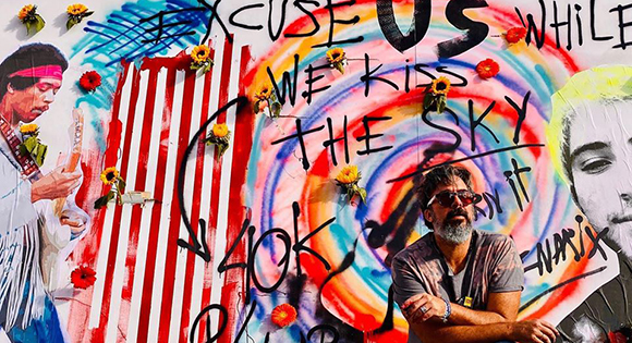 Artist Manuel Oliver with one of his murals honoring the 17 deaths.