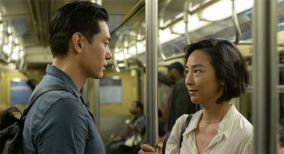 Teo Yoo as Hae Sung and Greta Lee as Nora on the subway in New York