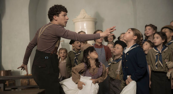 Jesse Eisenberg as Marcel entertaining a room of children