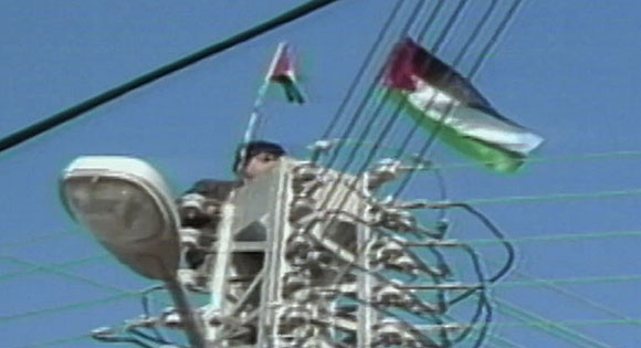 Palestinian boy forced to retrieve a flag from live electrical pole