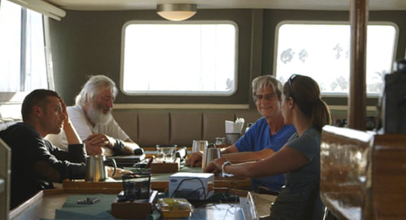 Director Joshua Zeman (left) and scientists looking for 52