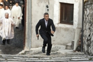 George Clooney as Jack and Paolo Bonacelli as Father Benedetto