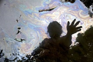 Cancer victim Maria Garofalo reflected in the stream behind her home in the Ecuadorean Amazon