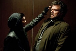 Rooney Mara as Lisbeth and Yorick van Wageningen as Bjurman