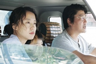 Jeon Do-yeon as Lee Shin-ae and Song Kang-ho as Kim Jong-chan