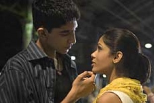 Dev Patel as Jamal and Freida Pinto as Latika